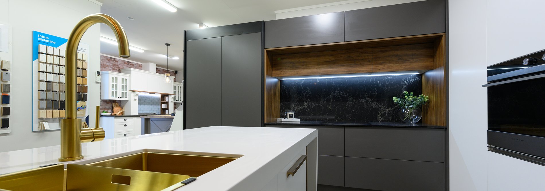 Kitchen showroom with white counter top and black cabinets