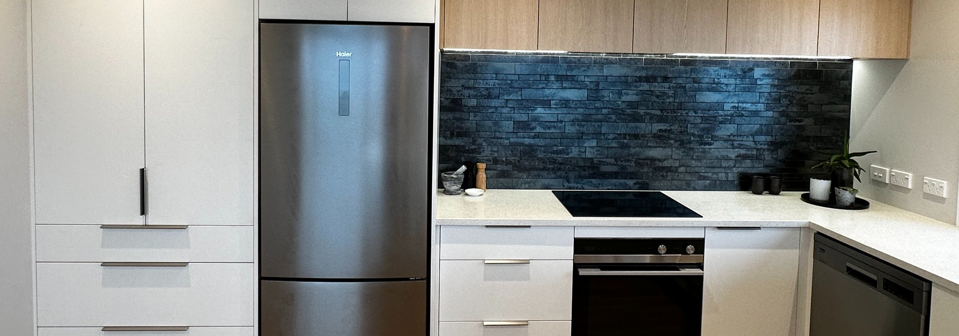 white and woodgrain kitchen with modern appliances