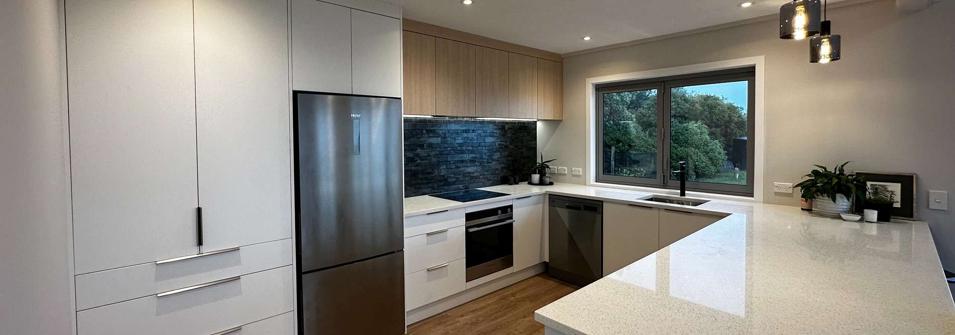 Modern white and light timber kitchen with appliances