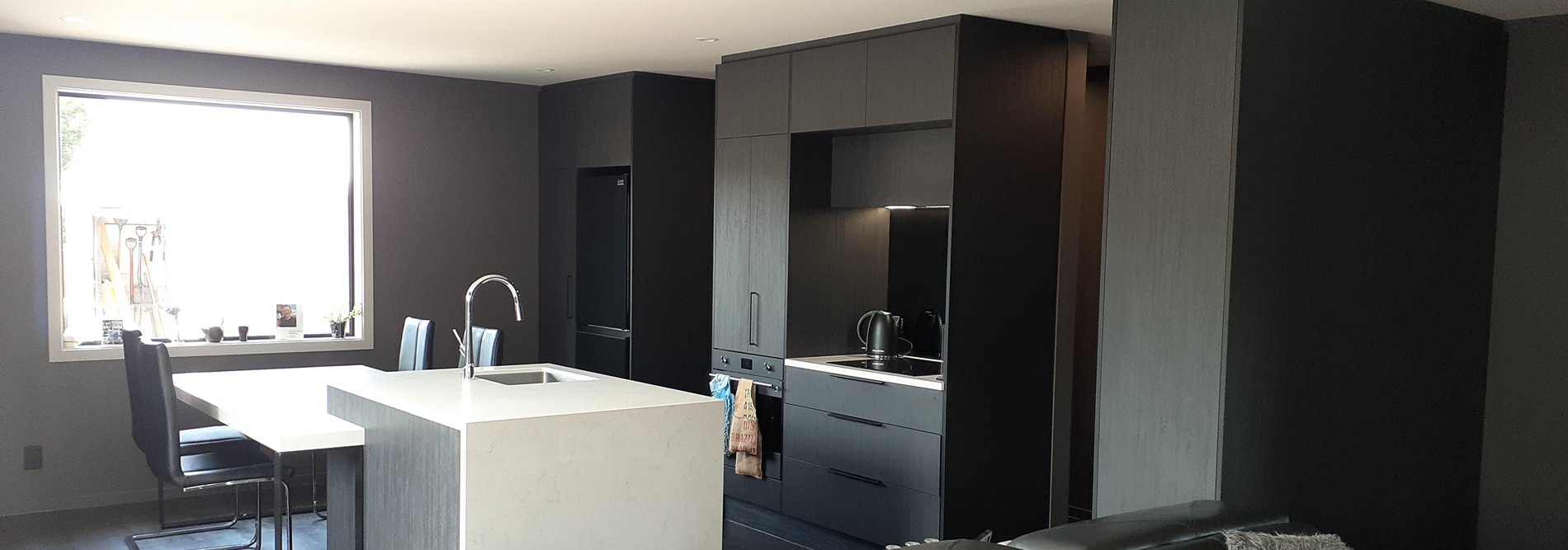 Kitchen with wooden black cabinet and white counter tops