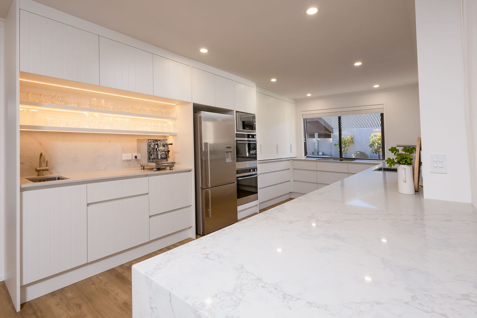 modern white kitchen with fitted appliances