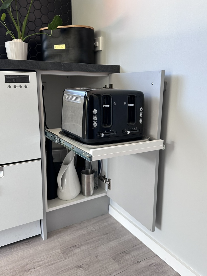 Grey and black kitchen with smart storage for small appliances